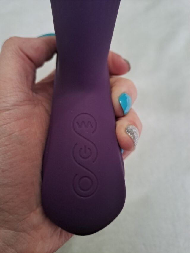 Wireless purple sex toy with control buttons for remote pleasure.