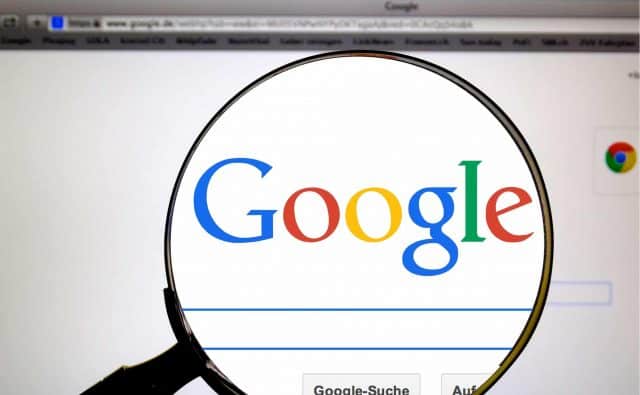 Google's logo seen through a magnifying glass with powerful browsing tools.