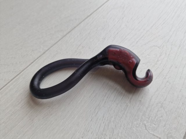 Squid-shaped flex silicone toy for adult pleasure, black and red, flexible and textured for enhanced sensation, commonly used as a sextoy or adult novelty item at sextechguide.com.