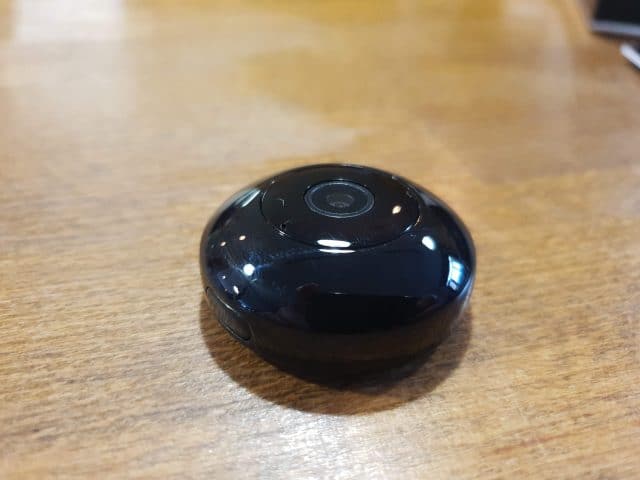 A small black CockCam sitting on top of a table.