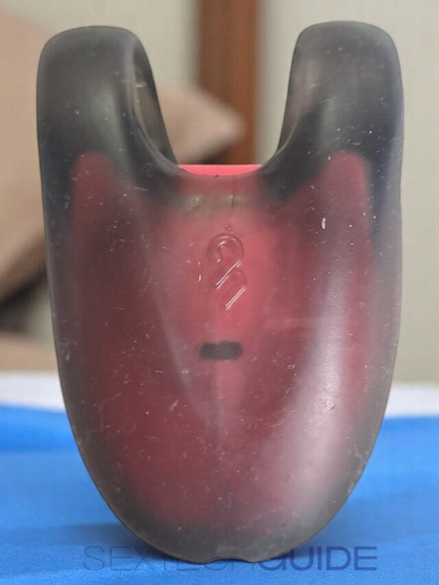 Rubber bicycle handlebar grip with black and red color, close-up shot.