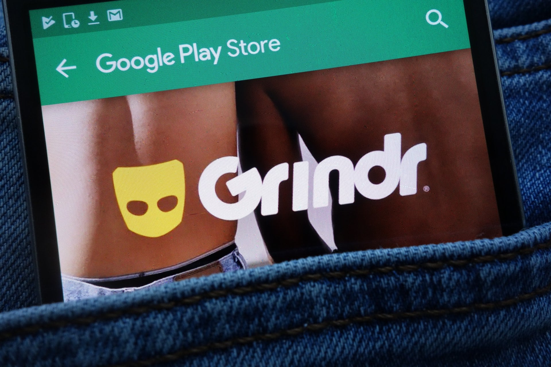 A smartphone with the Grindr logo in a pocket faces backlash over same-sex marriage comments.