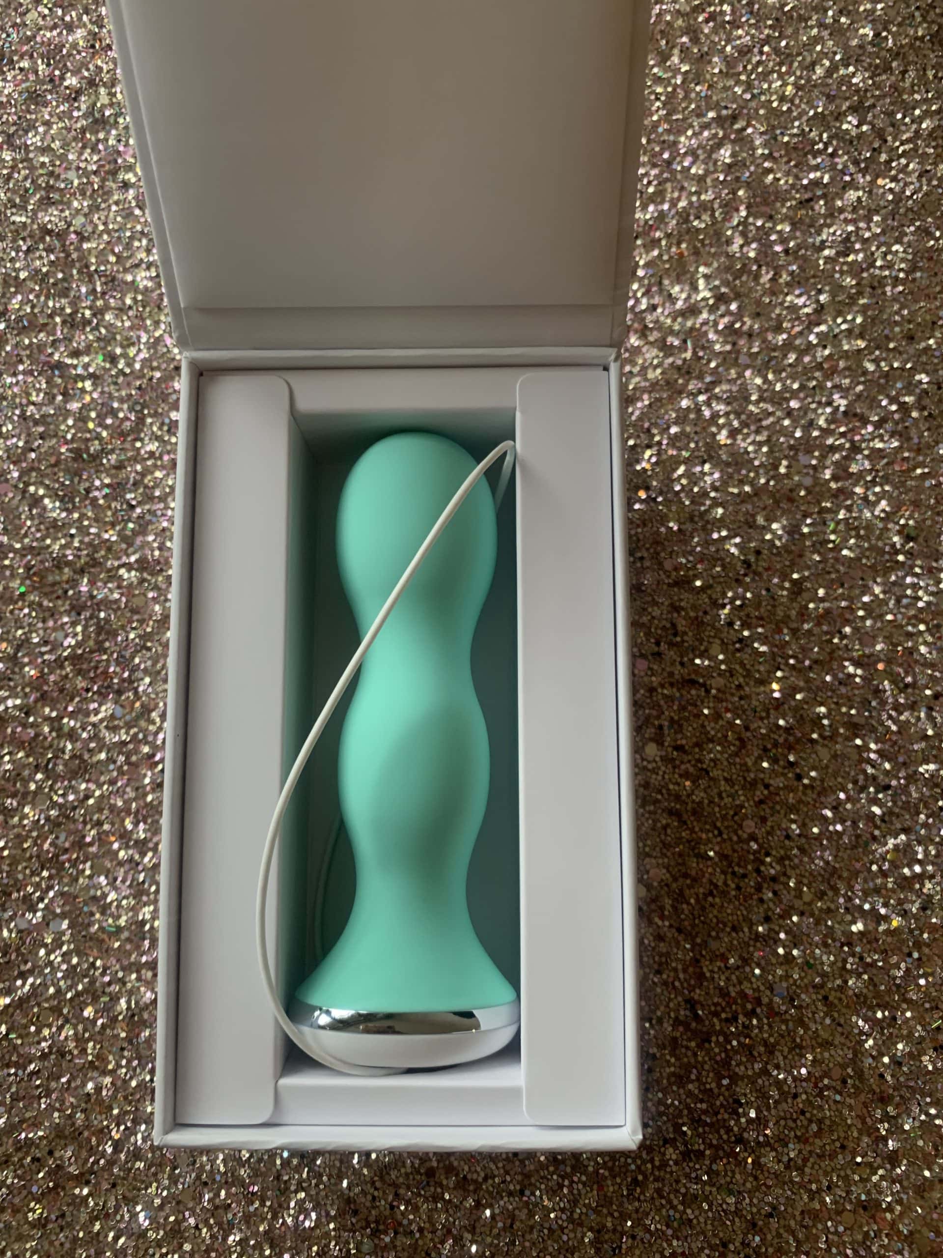 A teal perifit kegel exerciser is sitting in a box.