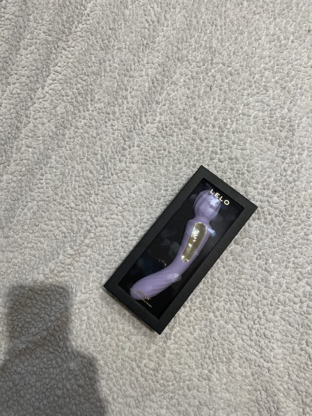 Luxury purple sex toy inside transparent display box for sensual pleasure and adult toy collection.
