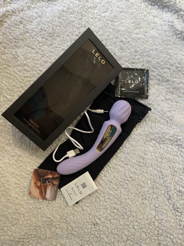 Flexible purple sex toy with gold accents and control buttons, USB charging cable, and accessories for enhanced intimacy and pleasure.