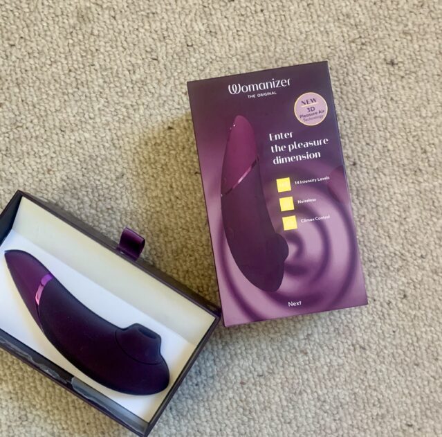 A purple vibrator, awaiting its Womanizer.