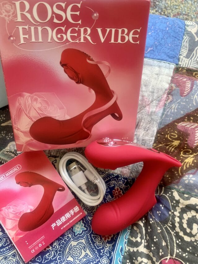 Silicone rose-shaped finger vibrator with remote control, USB charging cable, and user manual for men and women’s climax enhancement and sexual pleasure.