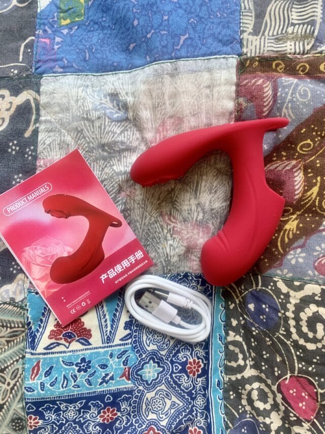 Rechargeable red sex toy with ergonomic design, USB charging cable, and user manual, perfect for advanced pleasure and intimate stimulation.