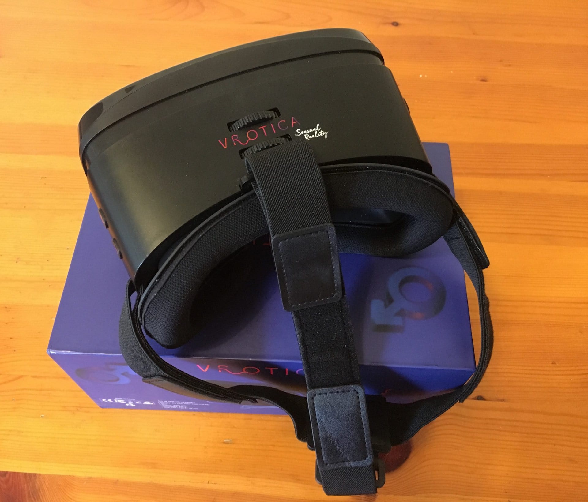 A black VR headset sitting on top of a box while being used for a VRotica review.