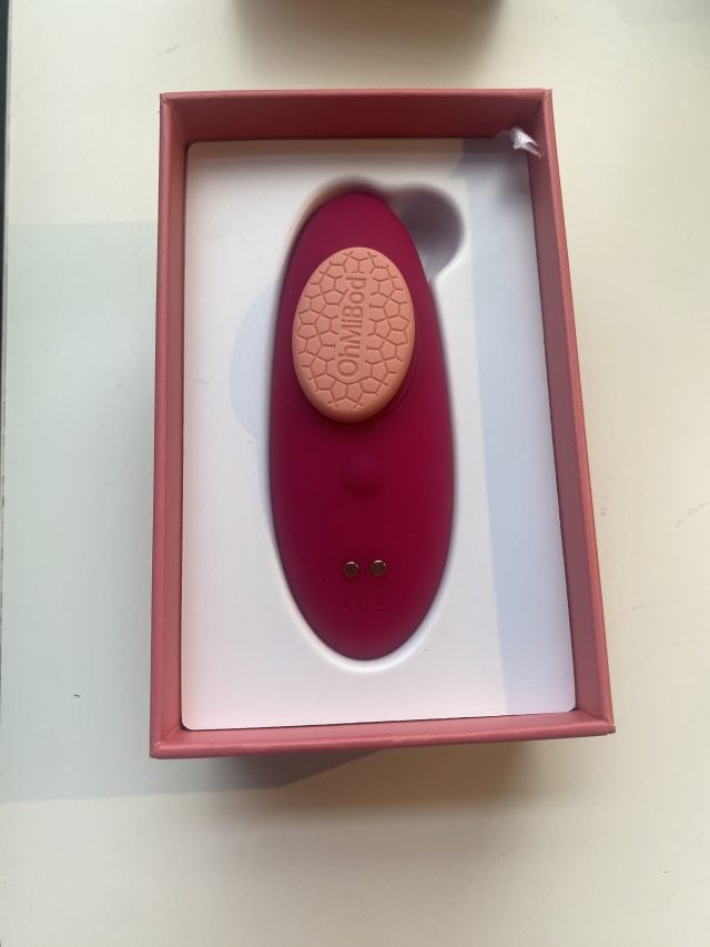 Wireless vibrating clitoral stimulator from OhMiBod, pink color, in branding box, designed for pleasure and intimacy enhancement, washable, rechargeable, app-compatible, discreet, perfect for adult needs.