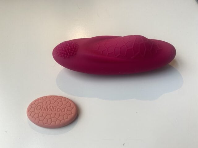 Silicone vibrating personal massager with textured surface and remote control for enhanced intimate pleasure.