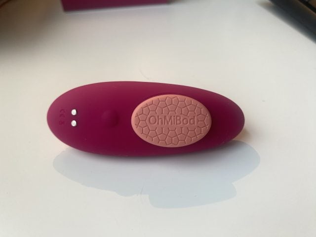 OhMiBod vibratory pleasure device for adult intimacy and personal pleasure enjoyment, ergonomic design, discreet, rechargeable, ideal for sexual wellness and sextech innovation, pink color.