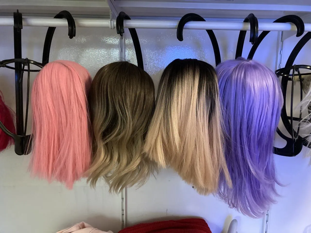 Colorful wigs on a rack at the Barbie Cyberbrothel.