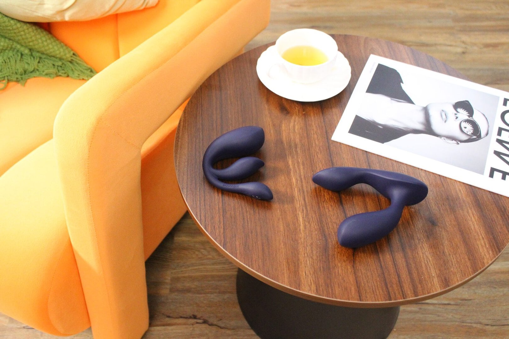 Intiwave Duet and Echo The Intiwave Duet (left) and Echo (right) vibrators on a wooden side table beside a cup of tea