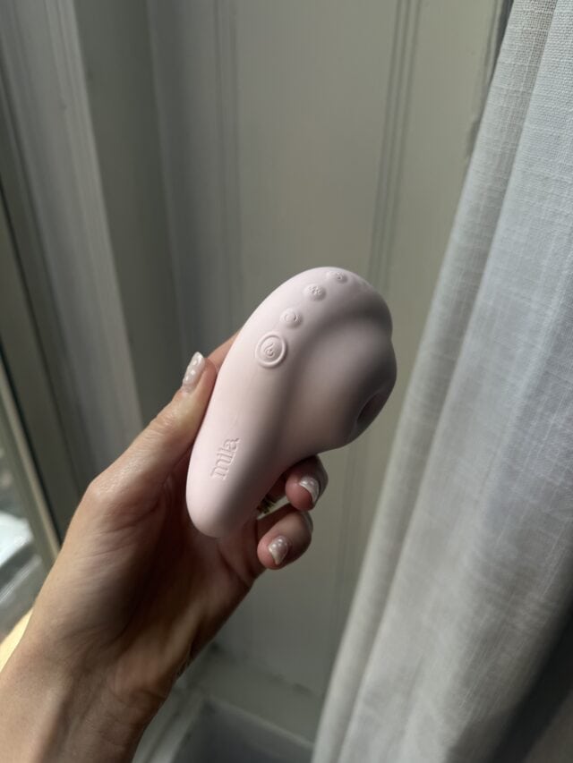 Mila Aura side view in hand