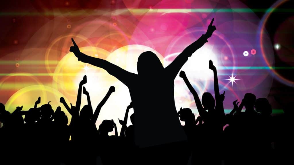 A person's silhouette enjoying a concert with the help of Tinder Festival Mode.