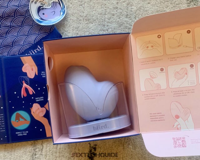 A box containing a pink Namii device and instructions.