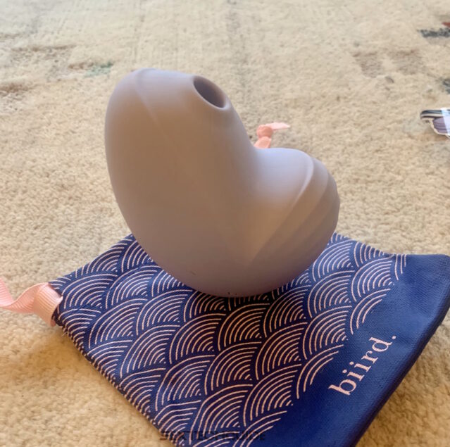 A purple sex toy called Namii rests on the floor.