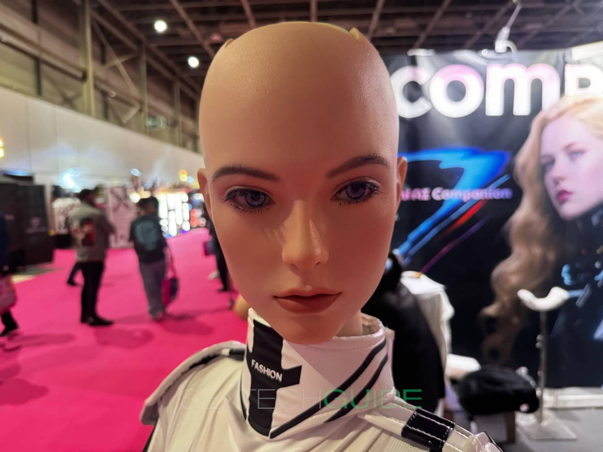Tenar the Ridmii sex robot at Venus Berlin 2025 pic by Jamie Fullerton A realistic female mannequin head with bald scalp and detailed facial features displayed at a sextech trade show, showcasing innovative sextech products and advancements in adult intimacy technology.