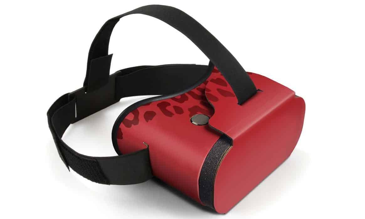 A red VR headset with a black strap, allowing independent lens adjustment.