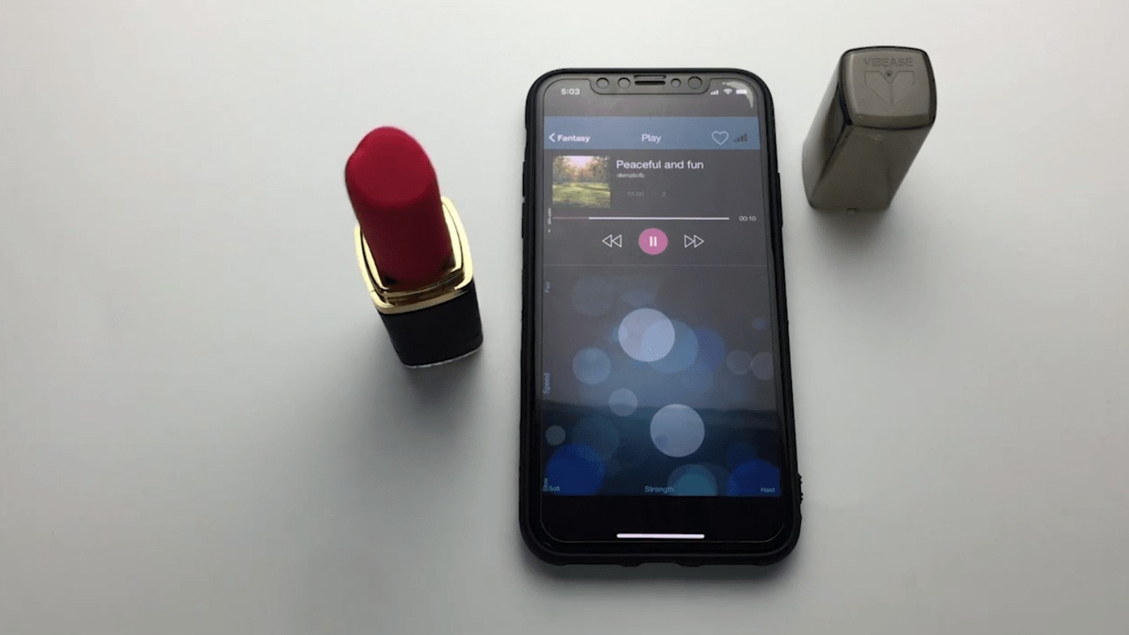 A smartphone paired with a Vibease Lipstick vibrator for a discreet and pleasurable experience.