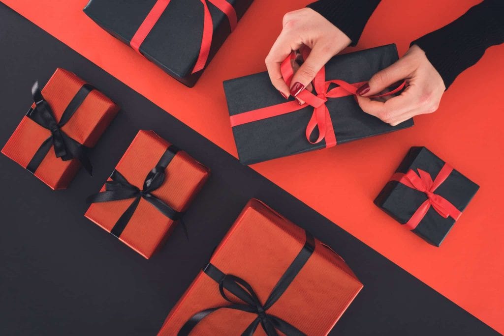 A woman is wrapping presents for SEXTECHGUIDE'S most read stories on Xmas Day 2018.