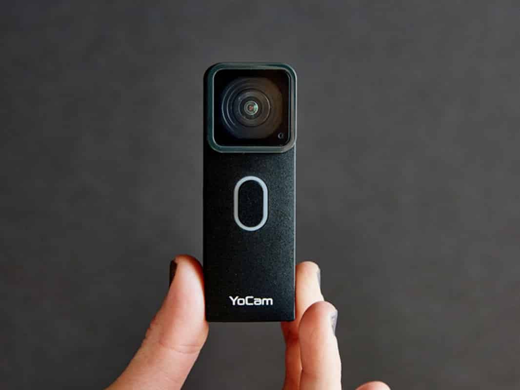 A person holding up a YoCam's tiny waterproof camera.