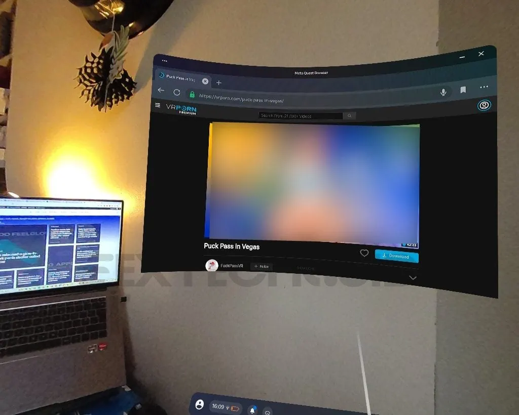 A room with a laptop and a TV on the wall, featuring Quest 3 passthrough VR porn capabilities.