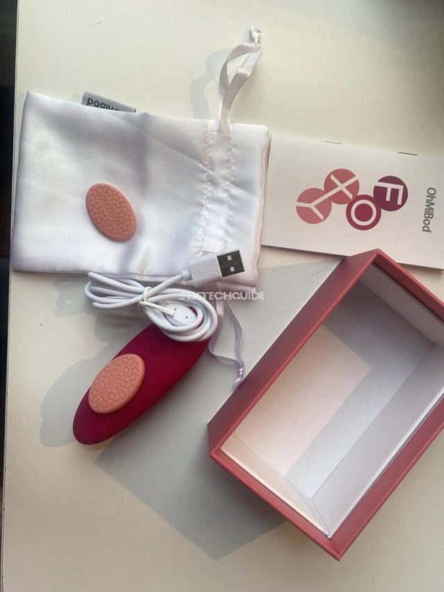 A foxy pink box containing a red and white tampon elegantly rests on a table.