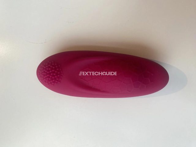 A foxy pink body brush on a white surface.