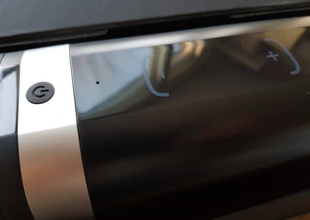 A close up of the Kiiroo Onyx2 phone with a button on it.