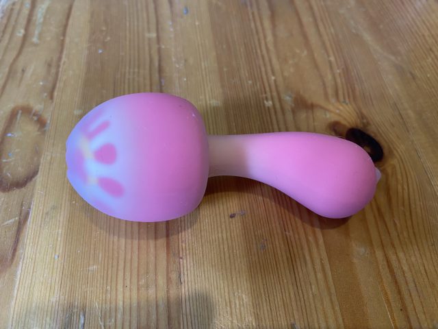 A PinkPunch Sunset Mushroom toy on a wooden table.
