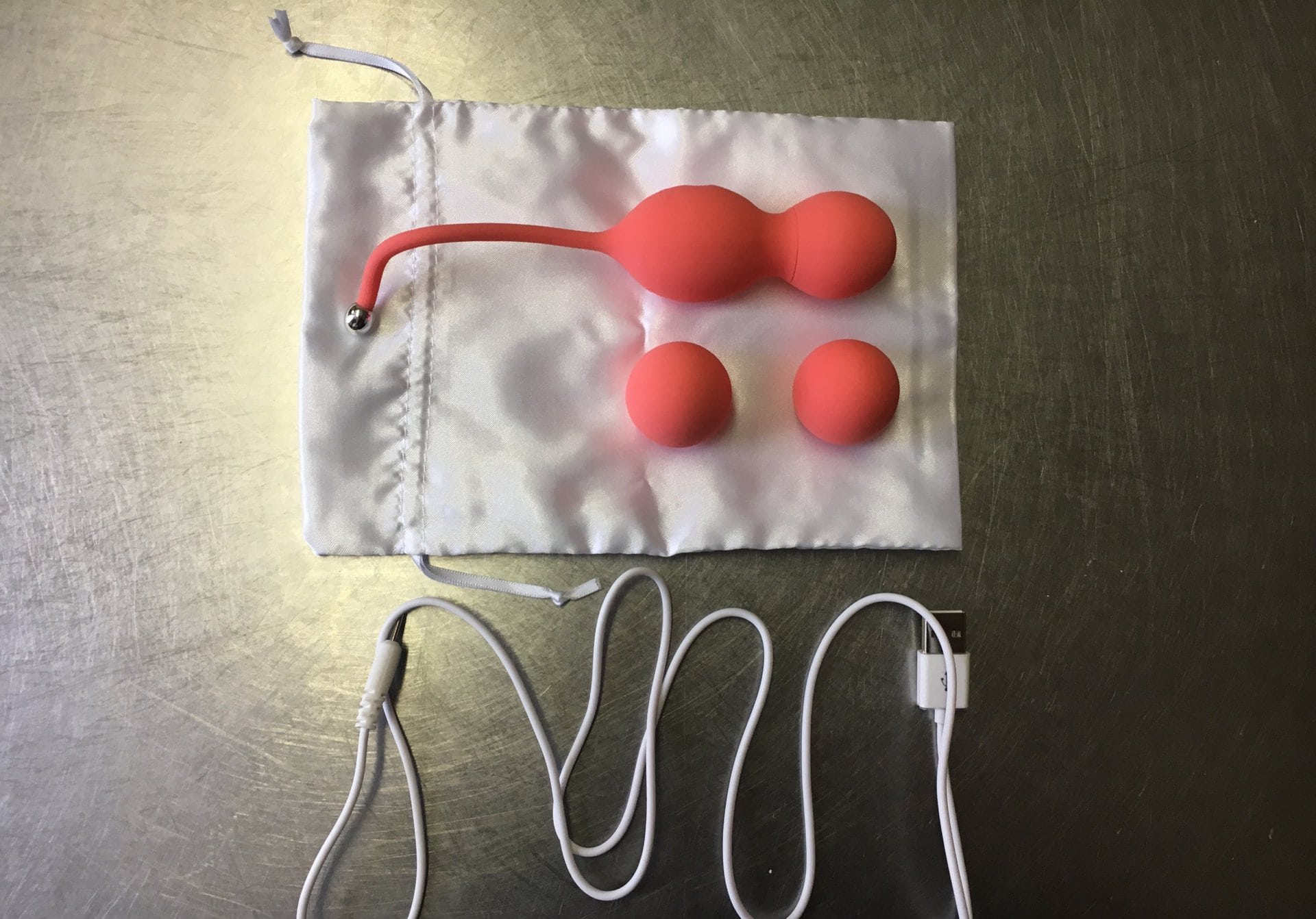A bag with two orange balls in it, customized with the WeVibe Bloom.