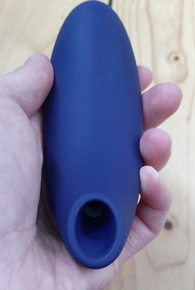A person holding a blue plastic ball-shaped We-Vibe Melt in their hand.