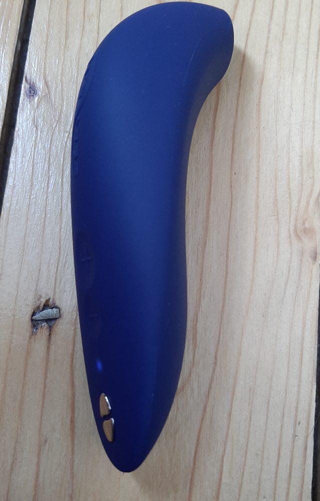 A blue We-Vibe Melt sex toy placed on a wooden table.