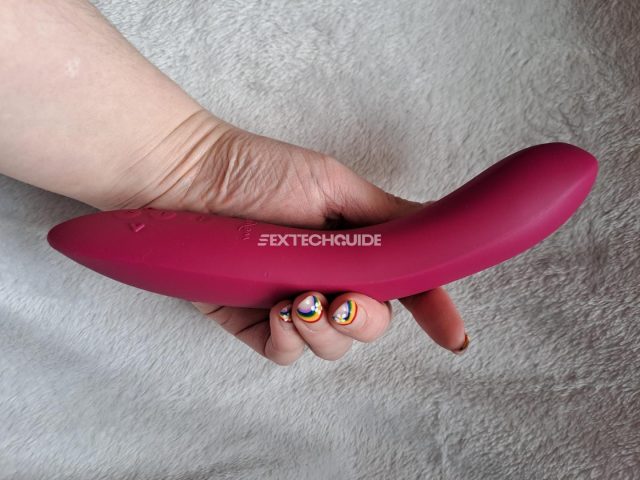 A woman's hand holding a pink We-Vibe Rave 2.