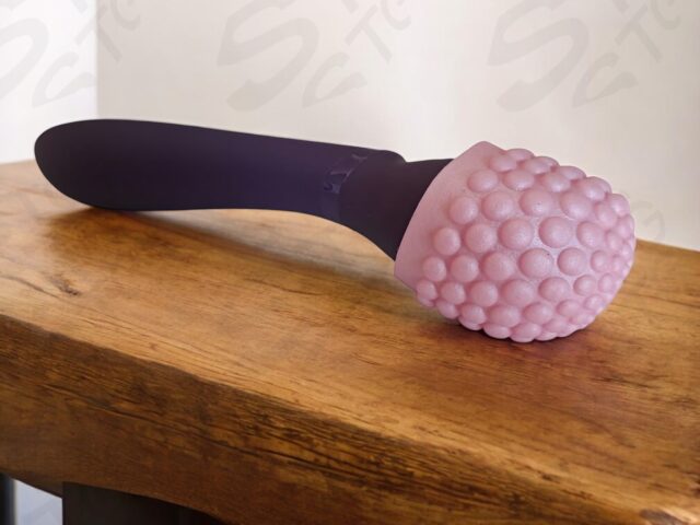 Ergonomic silicone vibration dildo with textured surface, designed for personal pleasure and intimacy enhancement, available in adult toy collections on SexTechGuide.